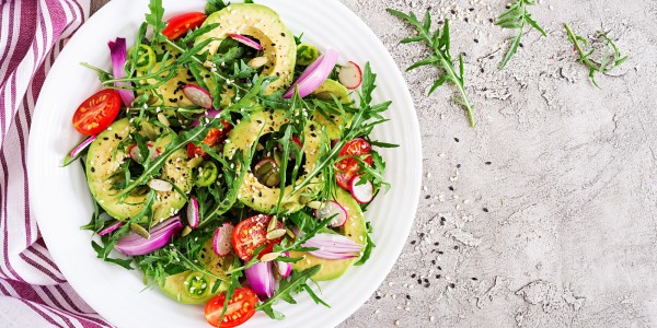 Tomatoes, avocado, arugula, radishes and sesame seeds